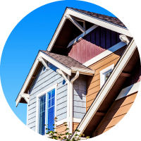 A colorful house with a bright blue sky behind it.